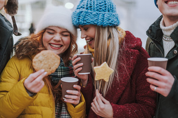 Positive delighted girls laughing at funny joke