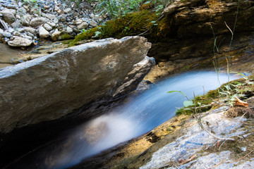 a tiny waterfall between rocks