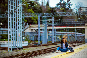 girl in a bad mood sitting at the station