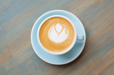 Cappuccino coffee on vegetable milk in a blue cup. Vegan coffee.