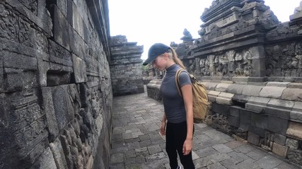 Tourists holding hands exploring the Borobudur temple in Java island,Indonesia