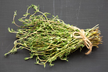 Raw organic fresh thyme on a black  background, side view. Closeup.