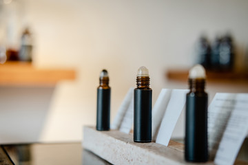 Roll on perfume in dark brown bottle packaging. Beauty blogging, salon concept