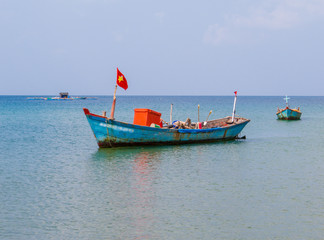 Naklejka na ściany i meble Traditional Vietnamese fisherman boat on Truong Beach (Vietnamese: Bai Truong)