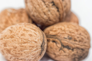 Close-up of five shelled walnuts over a white background stock macro photo