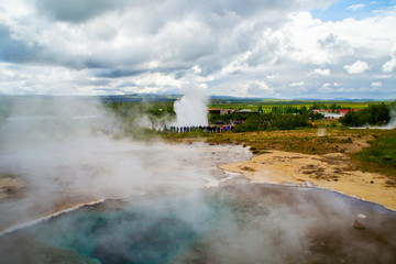 View of erupting Geysir, popular geothermal natural tourist travel attraction on Golden Circle, Iceland.