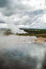 Fototapeta na wymiar View of erupting Geysir, popular geothermal natural tourist travel attraction on Golden Circle, Iceland.