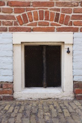 a basement window in a stone facade