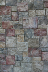 Fototapeta premium Colorful modern marble-like tile wall texture with blocks in varying hues of rose red, blue, and gray