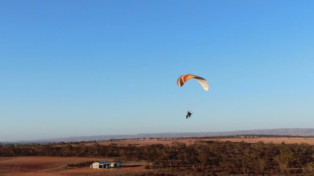 Paraglider having good time flying and enjoying air sports paramotoring