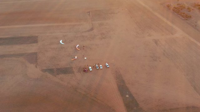Beautiful morning rays from rising sun giving light for paragliders arrived and setting up, preparing for paramotoring sport in huge Granite field in South Australia