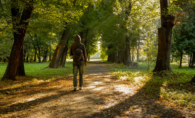 atmosphere moody life style introvert walking picture of incognito guy back to camera with backpack...