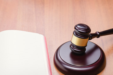 Right to a lawyer. Judicial law. Book for records. Fair trial. Judge's wooden gavel on the table.