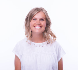 Portrait of blonde young woman standing and smiling over isolated background