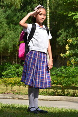 A Girl Student Saluting With Notebooks