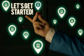 Text sign showing Let S Get Started. Business photo showcasing encouraging someone to begin doing something Male human wear formal work suit presenting presentation using smart device