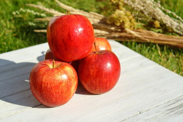 apples in a basket on wooden table