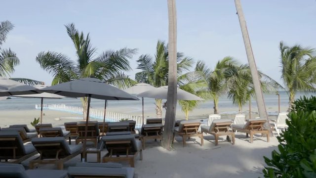 View of Canopy and relaxing chairs on the sandy beach near the sea. Summer holiday and vacation concept for tourism. Inspirational tropical landscape