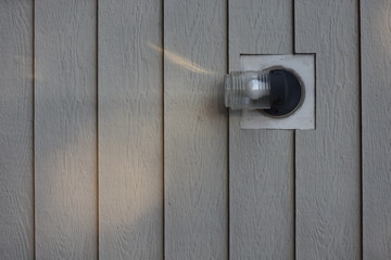 light on house with wood siding- vertical