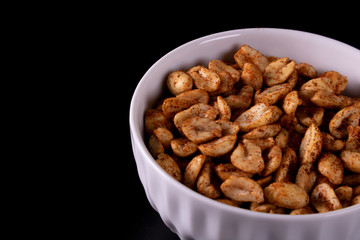 bowl with peanuts and black background
