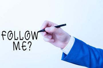 Text sign showing Follow Me Question. Business photo showcasing go or come after demonstrating or thing proceeding ahead Isolated hand above white background. Pointing pen in the hand on white