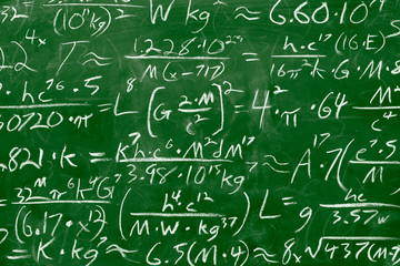 Math equations and formula written in chalk on green messy chalkboard background. School or scientific research concept.