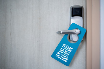 Closed door of hotel room with please do not disturb sign. Hotel Door Hanger Tags Mockup.