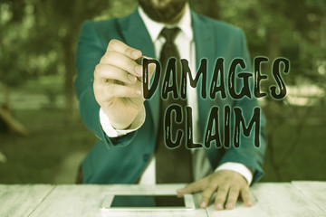 Writing note showing Damages Claim. Business concept for Deanalysisd Compensation Litigate...