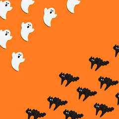 オレンジバックに沢山の白いオバケと黒猫が出会ってビックリしています　そしてコピースペース