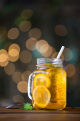 Lemon iced tea on wooden plate