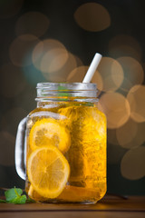 Lemon iced tea on wooden plate