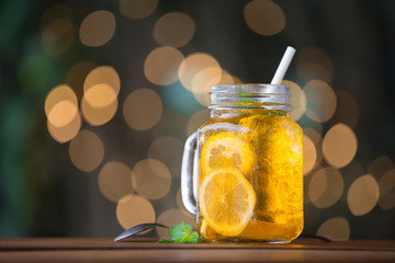 Lemon iced tea on wooden plate