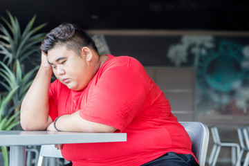 Overweight man looks desperate in the restaurant