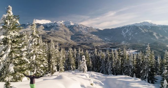 Woman Snowshoeing In The Mountains On A Sunny Day