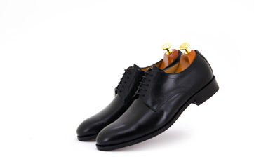 Black derby lace-up shoes with shoe tree (shape supporter) isolate on white background.