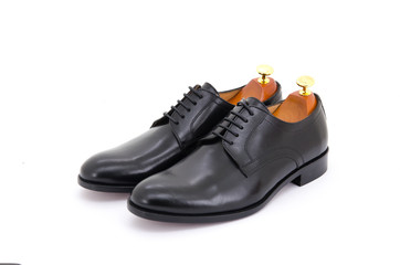 Black derby lace-up shoes with shoe tree (shape supporter) isolate on white background.