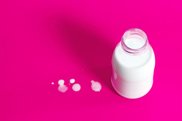 A bottle or jug of milk in pop art style with a pink background.