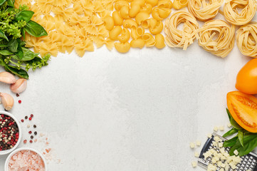 Different types of Italian pasta, fresh basil, orange tomatoes and mozzarella cheese