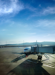 Transportation image of commercial passenger airplane and departure gate at airport