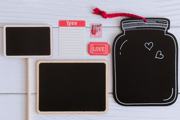 Flat lay black plain wooden tags decorate with stickers on white wooden background