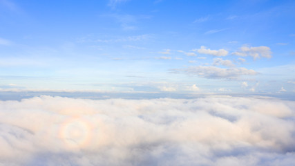 Aerial view White clouds in blue sky. Top view. View from drone. Aerial bird's eye view. Aerial top view cloudscape. Texture of clouds. View from above. Sunrise or sunset over clouds