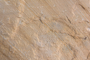 Weathered rock and sandstone wavy stripes closeup background