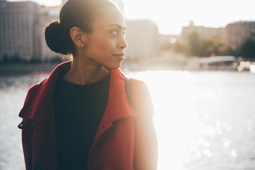 Beautiful portrait profile. Young girl, autumn mood. The river against the background.