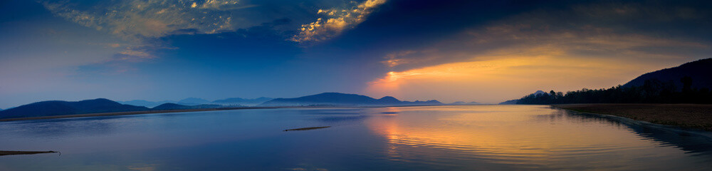 Panorama of Sunrise over Mahanadi river, Odisha, Eastern Ghat mountain range, copy space