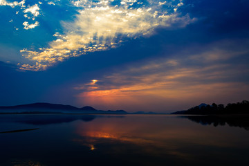 Fototapeta na wymiar Sunrise over Mahanadi river, Odisha, Eastern Ghat mountain range, copy space
