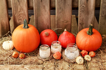 Autumn decorations with pumpkins, hay, leaves and beautiful lanterns.