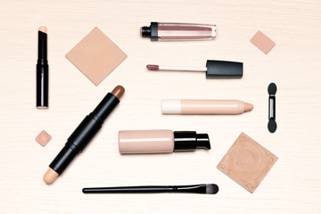 Day makeup set flat lay. Beauty products for natural make-up on light wooden table, top view