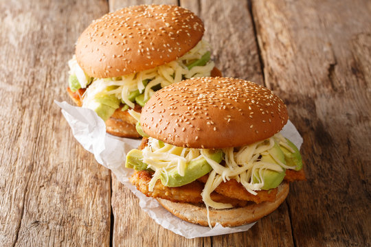 Mexican traditional sandwich with breaded meat, cheese and vegetables close-up. horizontal