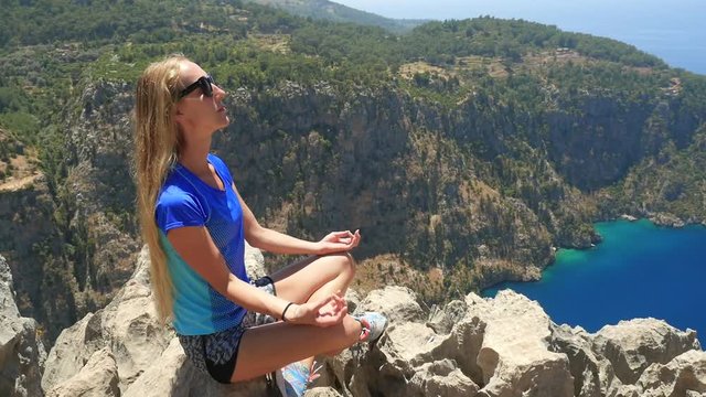Woman enjoying freedom and taking sun bath with beatiful viewn of Butterfly Valley on background