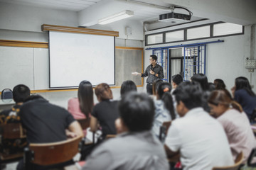 Teacher teaching studen in classroom at university. - 288447870